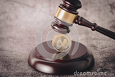 Judge's gavel holding a descriptive cryptocurrency coin. Editorial Stock Photo