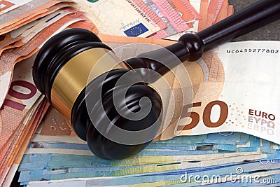 Judge`s gavel resting on euro banknotes close-up Stock Photo
