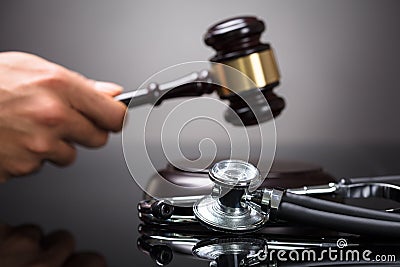 Judge`s Hand Striking Gavel Stock Photo