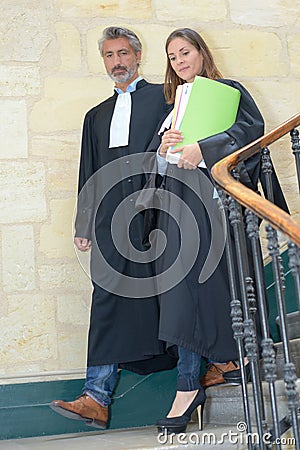Judges walking down staircase Stock Photo
