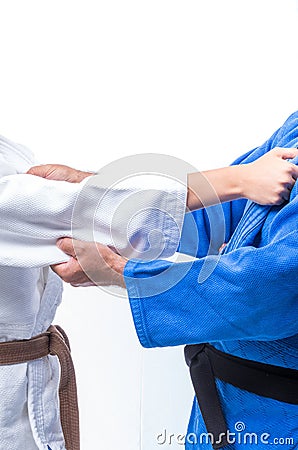 Judo Gripping between female judo brown belt and her sensei black belt Stock Photo