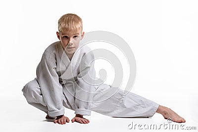 Judoka boy doing stretching at workout Stock Photo