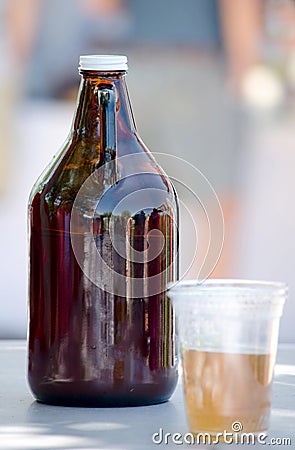 Jug and plastic cup of beer Stock Photo