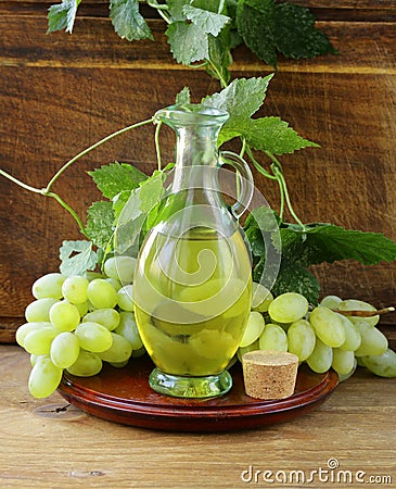 Jugful with grape seed oil Stock Photo
