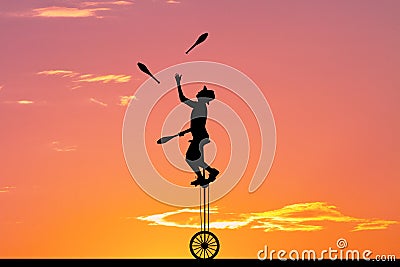 Juggler with ninepins at sunset Stock Photo