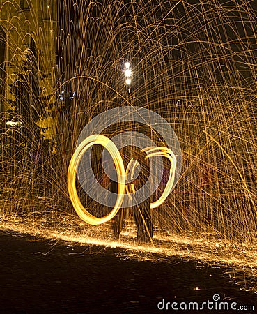 Juggling with fire in pair Stock Photo