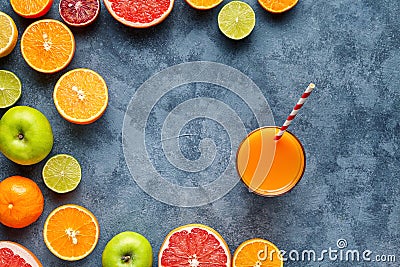 Juice or smoothie with citrus fruit, apple, grapefruit on blue background. Top view, selective focus. Detox, dieting Stock Photo