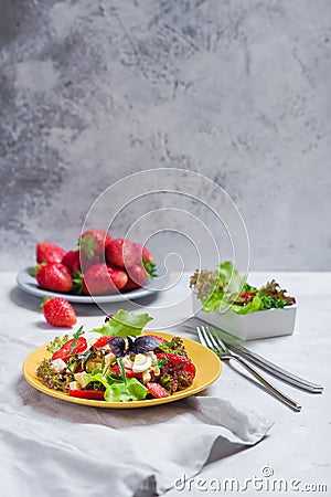 Juicy appetizer with salad, fresh strawberries, cheese and basil, and egg. Stock Photo