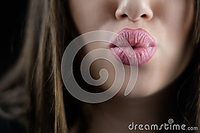 Juicy big lips of a young woman send a kiss Stock Photo