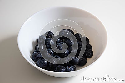 Juicy blackberries in a white bowl, berries in a white plate on a white background Stock Photo