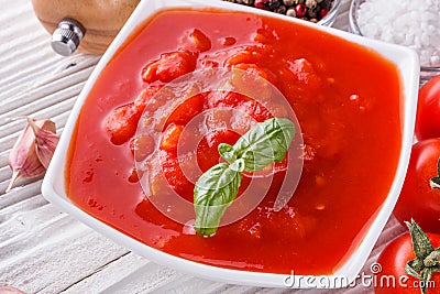 Juicy canned tomatoes on wooden rustic background Stock Photo