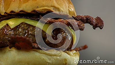 Juicy cheeseburger with crispy bacon in grilled brioche buns close up Stock Photo