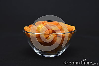 Juicy dried apricots in a glass bowl. Dried apricot fruit halves without a stone Stock Photo