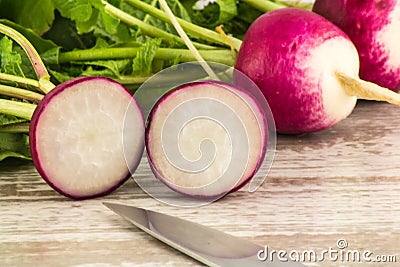 Juicy fresh radish in a cut on a white wooden background close up. Stock Photo
