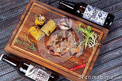 Juicy, fried, tender steak with vegetables and sauces on a special stand Editorial Stock Photo