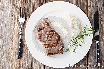 Grilled beef steak with rice and rosemary Stock Photo