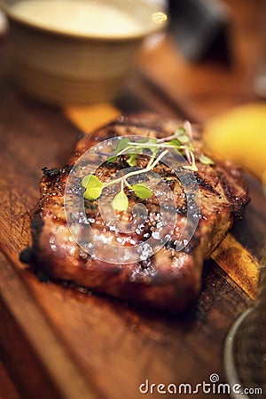 Juicy grilled beef steak on a wooden plate Stock Photo