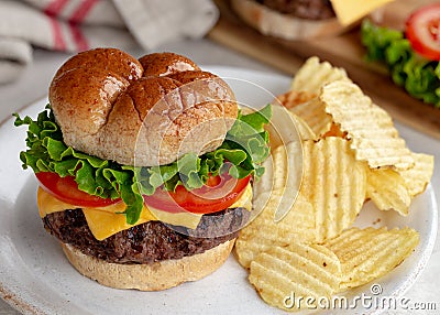 Juicy Grilled Cheeseburger and Chips Stock Photo