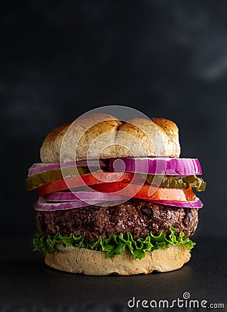 Juicy Grilled Hamburger on Whole Grain Bun Stock Photo