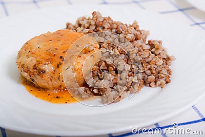 Juicy meat cutlet with tomato sauce with buckwheat Stock Photo