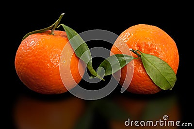 Juicy orange mandarin, two Half peeled mandarin on pure black background. Stock Photo