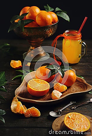 Juicy orange tangerines on a old wooden table Stock Photo