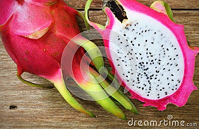 Juicy pink pitaya on wooden table Stock Photo