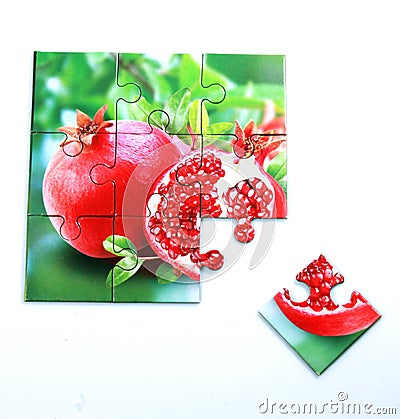 Juicy pomegranate and its half with leaves photo on puzzle boards Stock Photo