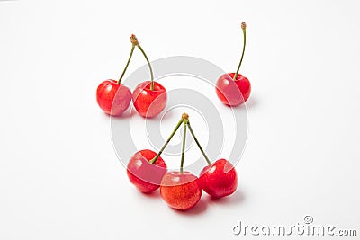 Juicy red cherries single double triple with stems in one frame on a white background Stock Photo