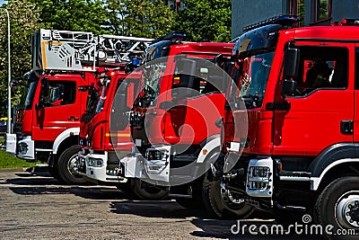 Juicy red fire trucks in front of the fire station. Stock Photo
