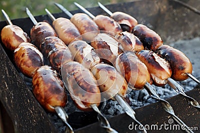 Juicy sausages grilled over charcoal Stock Photo