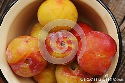 Juicy seasonal plums on the table macro Stock Photo