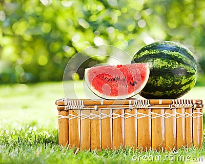 Juicy slice of watermelon on picnic hamper Stock Photo