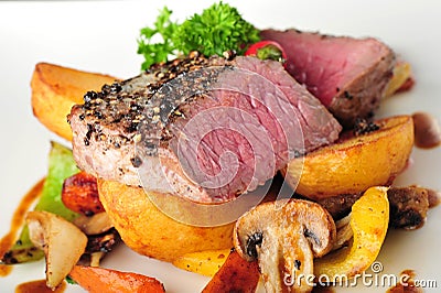 Juicy steak with baked potatoes and chilli Stock Photo