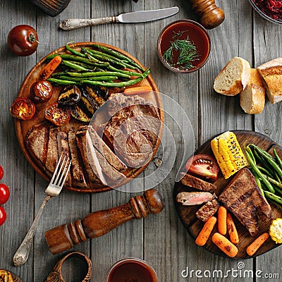 Juicy steak cooked on a grill with grilled vegetables Stock Photo