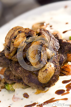 Juicy steak with mushrooms Stock Photo