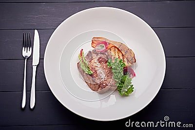 Juicy steak with potato and salad on white plate Stock Photo