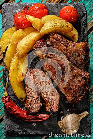 Juicy steak well done beef with potatos and tomatos Stock Photo