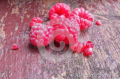 Juicy tasty raspberries. Red berries on an old shabby bench. Healthly food Stock Photo