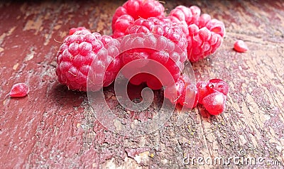 Juicy tasty raspberries. Red berries on an old shabby bench. Healthly food Stock Photo