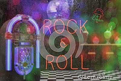 Jukebox in Bar with Neon Signs - Rock and Roll Rainy Window Image Stock Photo