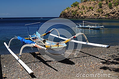 Jukung traditional small wooden Balinese outrigger canoe Stock Photo