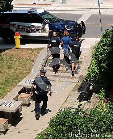 Police escort arrested man to car in Kitchener, Waterloo, Ontario Editorial Stock Photo