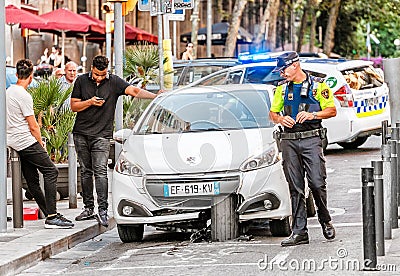 Police inspector at the Road and Traffic accident in the city center - a car crashed into a road Editorial Stock Photo