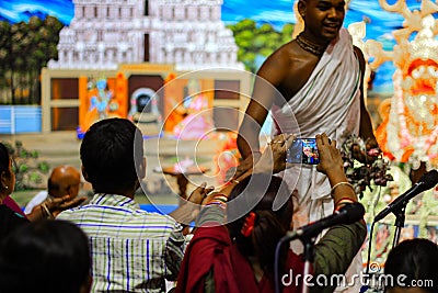 July 2018, Durgapur, West Bengal, India. Devotees clicking photos of a Purohit Panda at Rath Yatra Festival during Night. Rath Yat Editorial Stock Photo