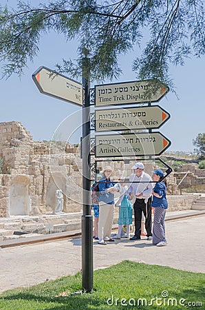July 30, - Information signs and a group of tourists in the ancient Byzantine park in Caesarea - Caesarea 2015 in Israel. Editorial Stock Photo