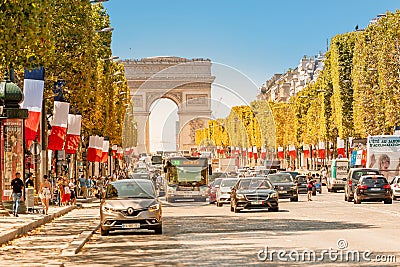 Buses and cars drive along Avenue Champs Elysees with the Arc de Triomphe in the background Editorial Stock Photo