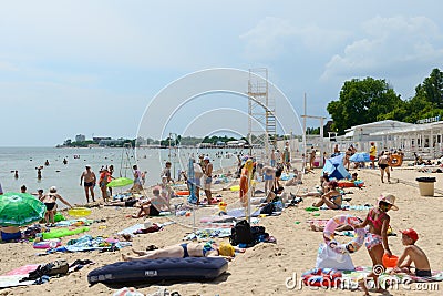People swim and tan on the beach. Yevpatoria. Russia Editorial Stock Photo