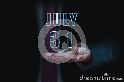 july 31st. Day 31of month, announcement of date of business meeting or event. businessman holds the name of the month and day on Stock Photo