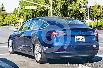July 9, 2020 Sunnyvale / CA / USA - Tesla Model 3 waiting at a traffic light in Silicon Valley Editorial Stock Photo